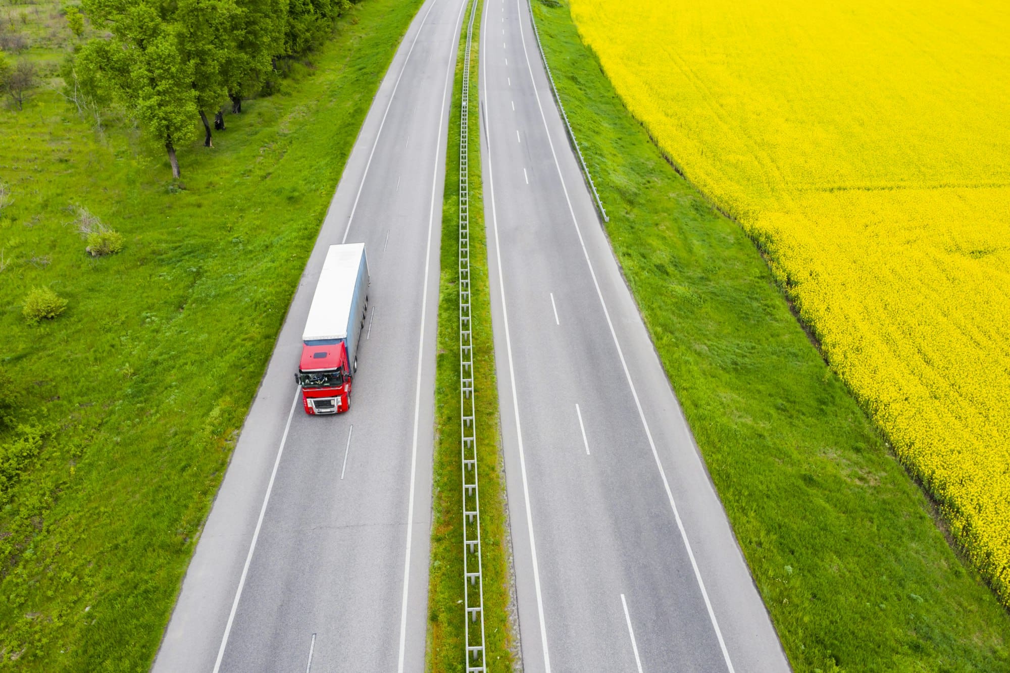 Aerial view of a truck on the highway at sunset. Shipping and delivery